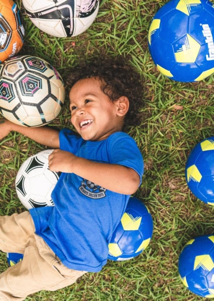 Happy child in soccer balls